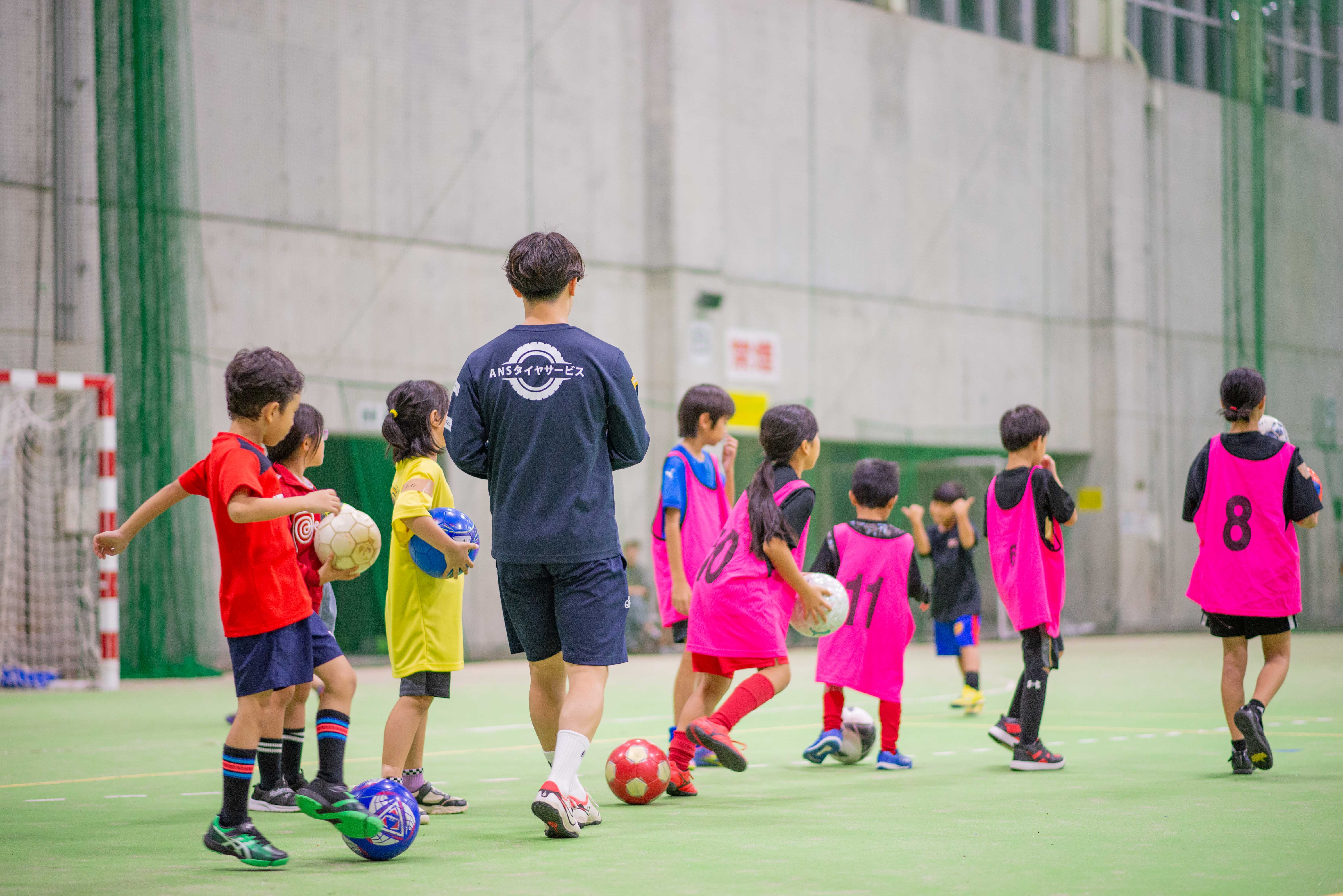 晴天の中でサッカーを楽しむ子どもたち